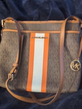 Michael Kors Brown Crossbody with Orange and White Stripe and Gold Logo.